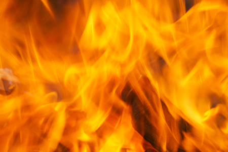 A close up of intense red flames in a fire. blurry.