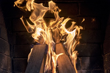 Frozen bright fire in the fireplace. Bright fire in the fireplace close-up.の写真素材