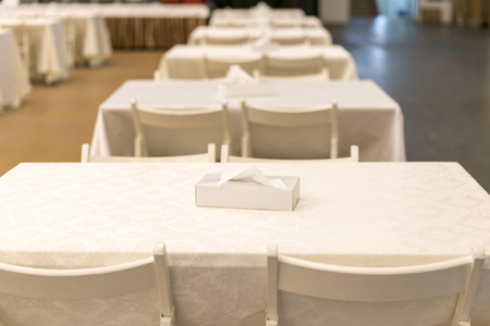 Empty tables in a cafe with beige tableclothsの写真素材