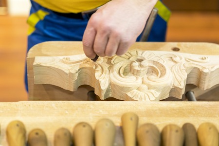Hand of carver carving wood.の写真素材