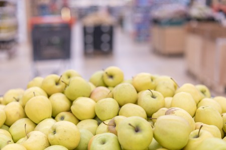 Mountain of yellow apples in the store. food rich in fiber. the most useful fruit