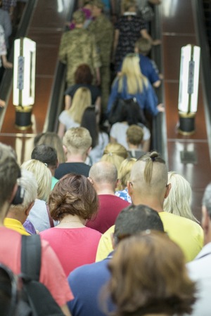 People on the escalator in the Metro. people in escalators.
