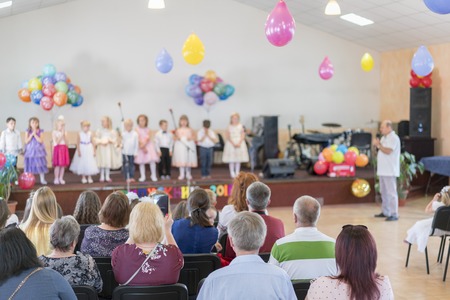 Children's holiday in kindergarten. Children on stage perform in front of parents. image of blur kid 's show on stage at school , for background usage. Blurry.の写真素材