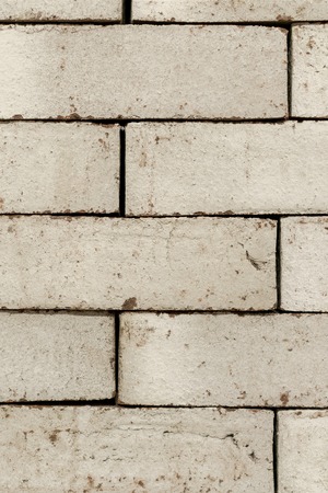 Wall of an old uneven brown brick. background.の写真素材