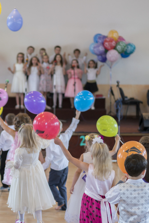 Children's holiday in kindergarten. Children on stage perform in front of parents. image of blur kid 's show on stage at school , for background usage. Blurry. Balloonsの写真素材