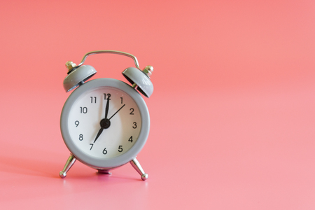 alarm clock on pink background. Vintage style alarm clock with copy space for textの写真素材