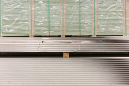 Pallet with plasterboard in the building store. Warehouse with plasterboard. sheets of plasterboard on pallets. Construction Materials. Drywall warehouseの写真素材
