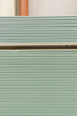 Pallet with plasterboard in the building store. Warehouse with plasterboard. sheets of plasterboard on pallets. Construction Materials. Drywall warehouse. vertical photo.の写真素材