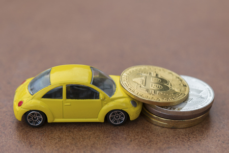 Model of car on background of coins, concept of car loan, car insurance, leasing, transport tax.の写真素材
