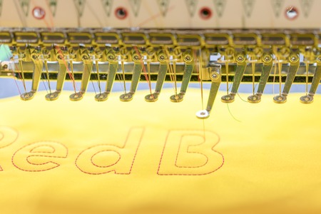 Computerized embroidery machines. sewing machine on blurred background. textile workshop. closeup.の写真素材