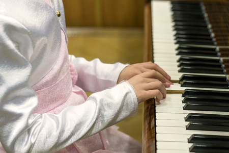 Children's hands on piano keys. children's hands are playing the pianoの写真素材