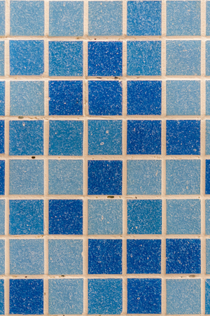 blue tile wall high resolution real photo. Blue glass mosaic in the bathroom. vertical photo