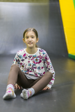Happy girl on trampoline. vertical photo.の写真素材