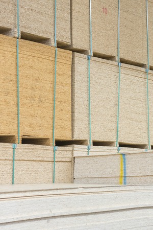 timber in warehouse. Pallet with boards in the hardware store. Packed boards in the building store. building materials. warehouse with variety of timber for construction and repair. vertical photoの写真素材