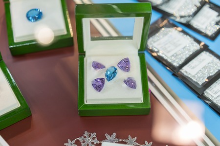 purple and blue jewels in a case. Rubies in a case