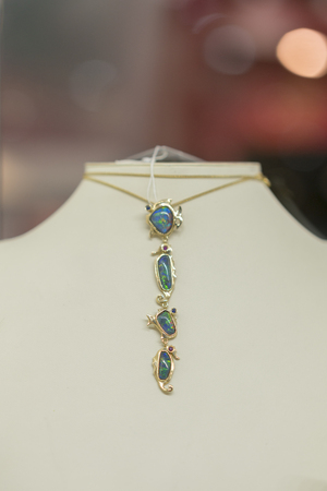 Stylish necklace with gemstones on the light background. vertical photo.の写真素材