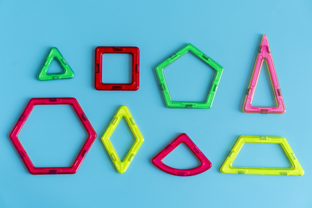 Children's bright color magnetic constructor on blue background. intellectual toy.の写真素材