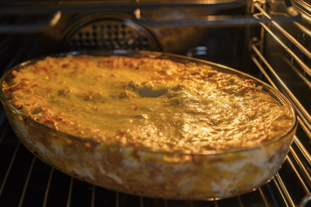 Dish Of Lasagne Cooking Inside Oven. Baking tray with spinach lasagna in oven.の写真素材
