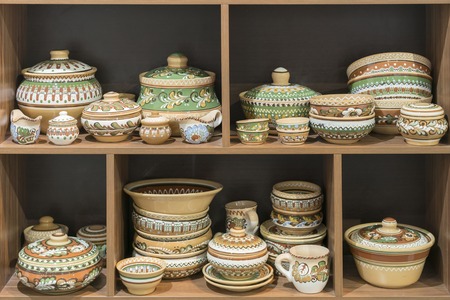 Variety of Colorfully Painted Ceramic Pots in an Outdoor Shopping Market. pottery in the shop...