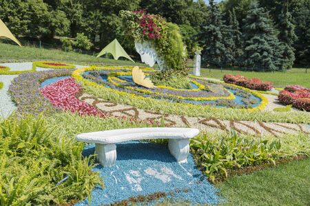 Landscape View of a Beautiful Landscape Garden with a Freshly Mowed Lawn and Flowerbeds in Bloom. Big beautiful flower bed of flowers. Flower garden.の写真素材