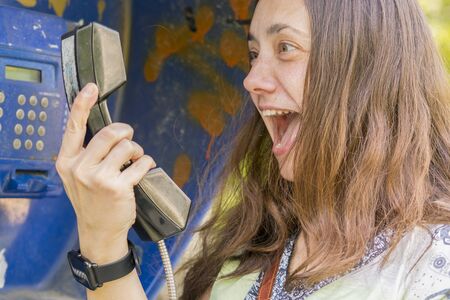 Woman shouting into the handset. Concept of quarrel scandal and incompetence.