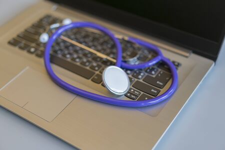 Stethoscope on laptop keyboard. Health care or IT security concept. Laptop repair concept. Computer repair concept Close-up view. Hardware.の写真素材