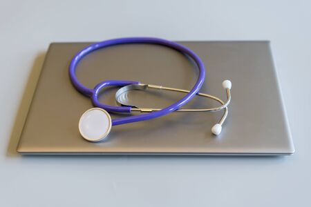 Stethoscope on laptop keyboard. Health care or IT security concept. Laptop repair concept. Computer repair concept Close-up view. Hardware.の写真素材