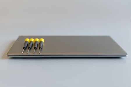 Screwdrivers on a laptop. computer repair concept. copy space.