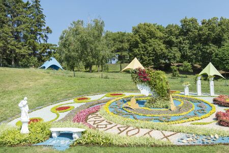 Landscape View of a Beautiful Landscape Garden with a Freshly Mowed Lawn and Flowerbeds in Bloom. Big beautiful flower bed of flowers. Flower garden.の写真素材