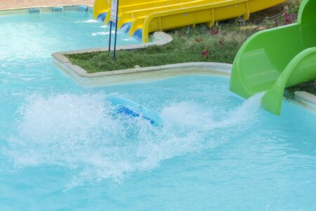 Colourful plastic slides in aquapark in the sunset. sliders, water park.