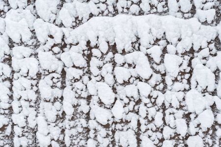 Snow on the fence. Winter natural snow background.