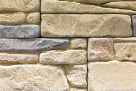 Light brown wall made of decorative stone. Beige stone for decoration. background.の写真素材