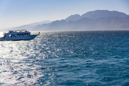 White yacht on a background of mountains. concept of sea recreation and tourism.の写真素材