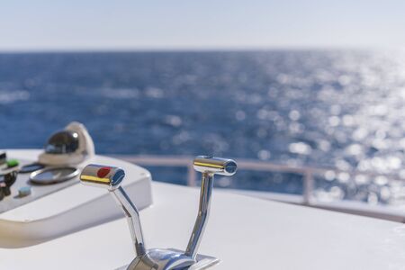 Nautical ships control panel on the captains bridge. yacht control knobs against the sea.の写真素材