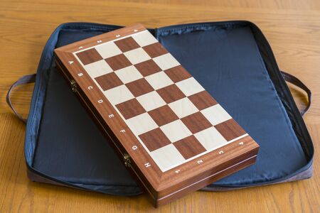 closed checkerboard close-up. Closed chessboard for chess game on wooden table.