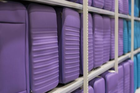 purple suitcases on a shelf in a store. Travel concept.の写真素材