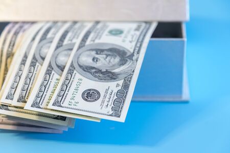 Dollars in a box in the sunlight. Dollars in a box in the sunlight. Open box with dollars.