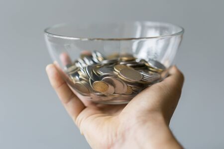 coins in a piggy bank vase. saving money in jar with American dollors , cash. Concept of...