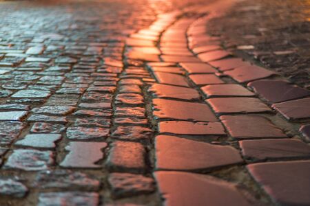 Paving stone vintage road cover. Evening road in a historical place. texture paving stones night...