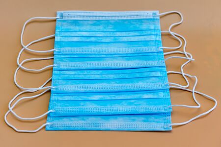 Medical masks on an orange background. Face mask protection against pollution, virus, flu and...