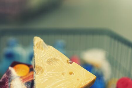 Cheese in a shopping cart. toned.の写真素材