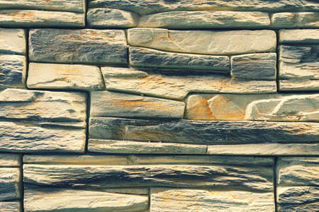 Stacked stone wall, natural stone cladding. Stone wall for background, Slab stone wall texture. Wall...