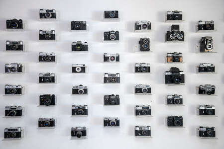 Ukraine, Kiev, 5 August 2020. Collection of vintage cameras and camera lens well organized, top view. Group old cameras. On white backgroundのeditorial素材