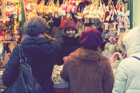 Woman choosing toys at Christmas market. woman chooses souvenirs at the Christmas market. back view....