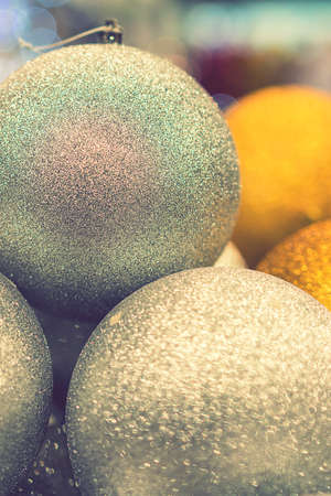 Golden Christmas balls, Christmas toys. Christmas tree decoration toys. Christmas concept. toned. vertical photo.の写真素材