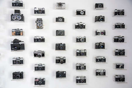 Ukraine, Kiev, 5 August 2020. Collection of vintage cameras and camera lens well organized, top view. Group old cameras. On white backgroundのeditorial素材