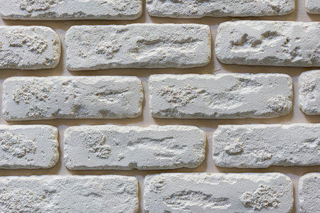 Seamless texture of white decorative stacked stone, natural stone cladding. brick background. close up. Backgroundの写真素材