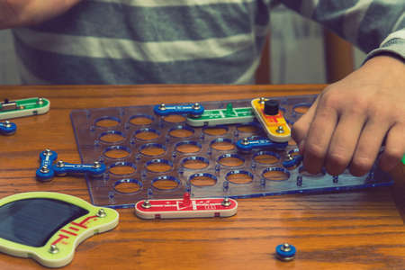 Cropped shot of a girl building a robot details close up education science technology robotics futuristic electronic mechanic developing creativity constructor playing toys concept. tonedの写真素材
