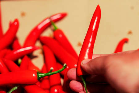 man buys a hot red peppers in the store. first person view man buy hot peppers in the store. tonedの写真素材