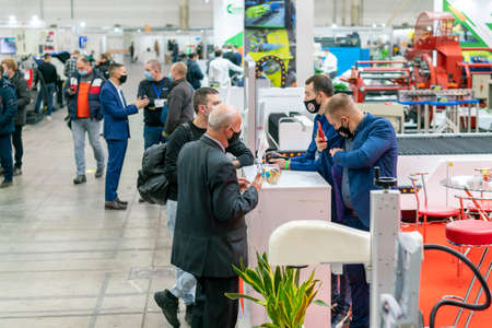 Kiev, Ukraine November 25 2020. Industrial Exhibition during a pandemic. People at the exhibition wearing medical masks. Exhibition and social distanceのeditorial素材